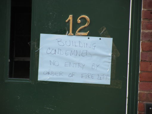 Sign reading "Building condemned. No entry by order of  Fire Dept"